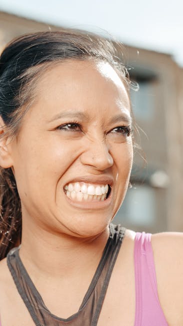 Woman feeling joyful and energetic while practicing yoga outdoors